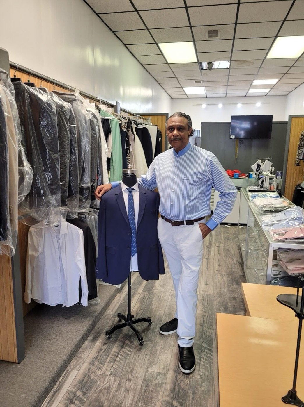Thomas in the shop beside a navy suit